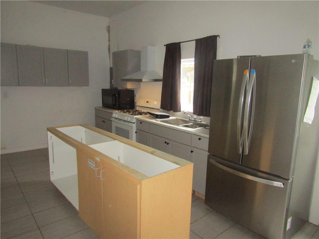 521 Williams Street Confluence, PA 15424 - Photo 26 of 38 a kitchen with stainless steel appliances a refrigerator stove and sink