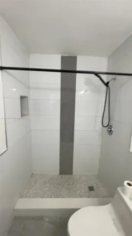 a bathroom with a shower and toilet