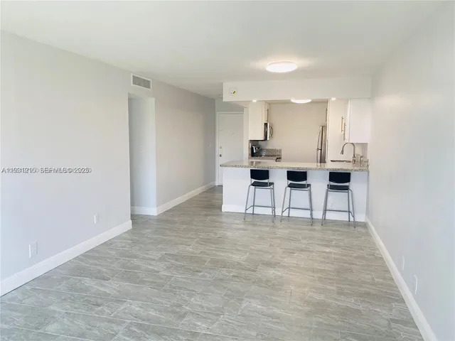 a view of kitchen with table and chairs