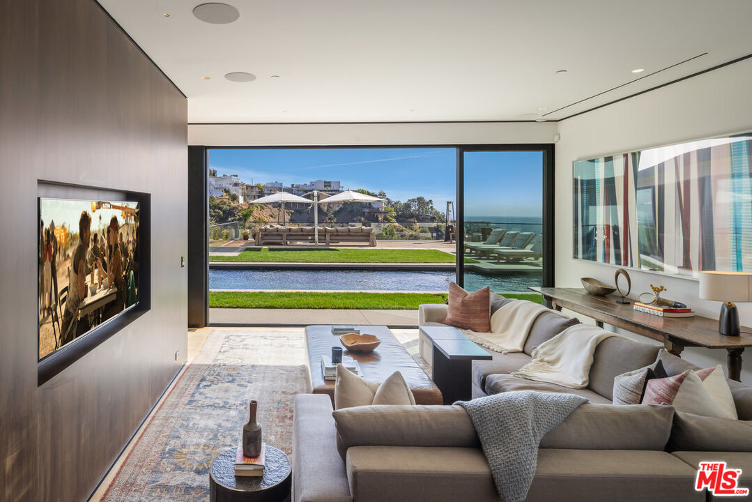 1877 Rising Glen Road Los Angeles, CA 90069 - Photo 12 of 29 a living room with furniture and a floor to ceiling window