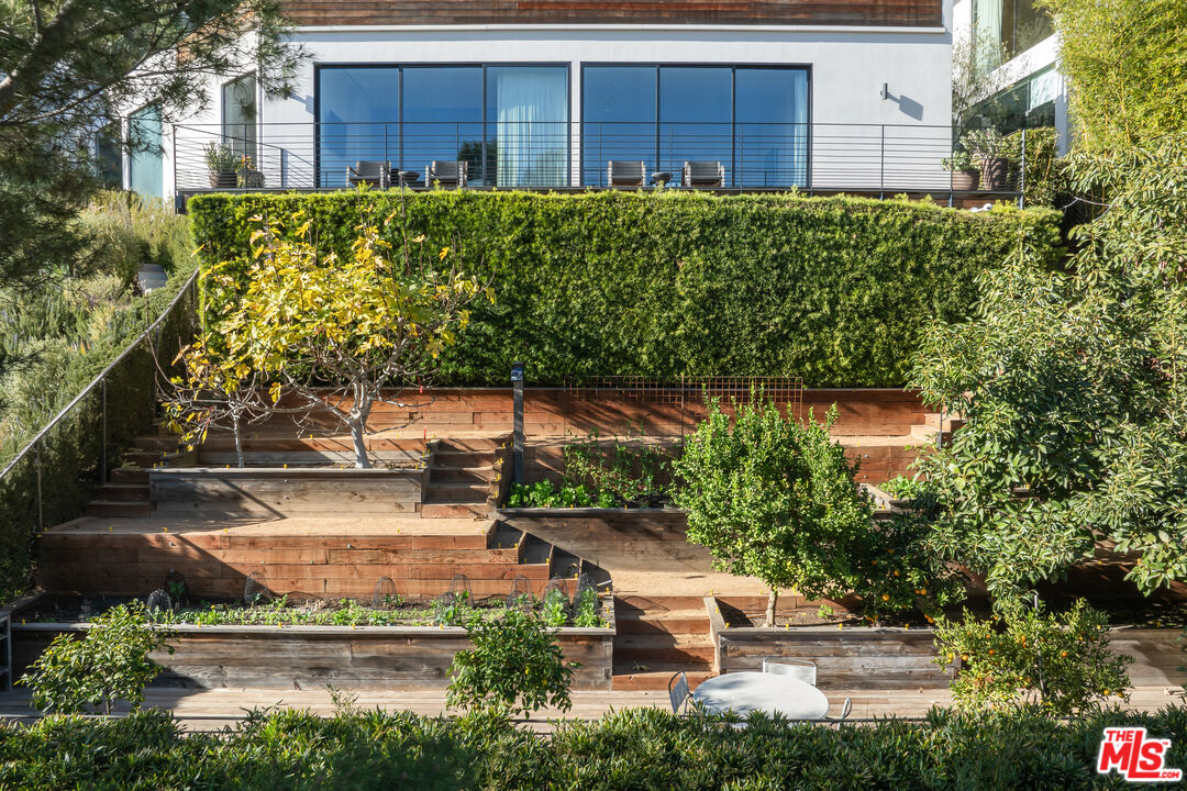 1877 Rising Glen Road Los Angeles, CA 90069 - Photo 16 of 29 a backyard of a house with lots of green space and fountain