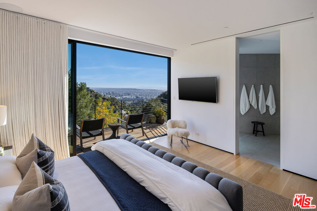 1877 Rising Glen Road Los Angeles, CA 90069 - Photo 18 of 29 a living room with furniture and a flat screen tv