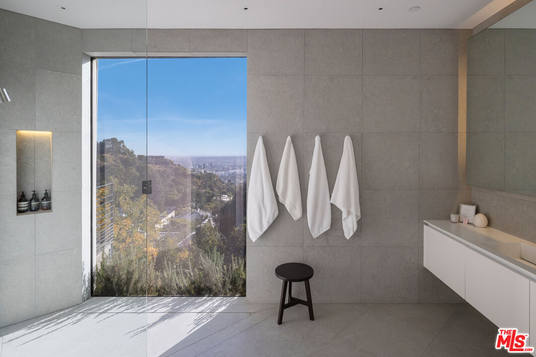 1877 Rising Glen Road Los Angeles, CA 90069 - Photo 19 of 29 a bathroom with a sink and a mirror