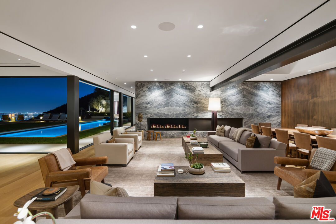 1877 Rising Glen Road Los Angeles, CA 90069 - Photo 21 of 29 a living room with furniture and a flat screen tv