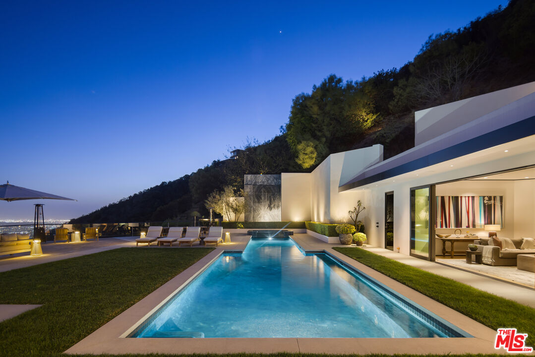 1877 Rising Glen Road Los Angeles, CA 90069 - Photo 25 of 29 a view of a swimming pool with an outdoor seating