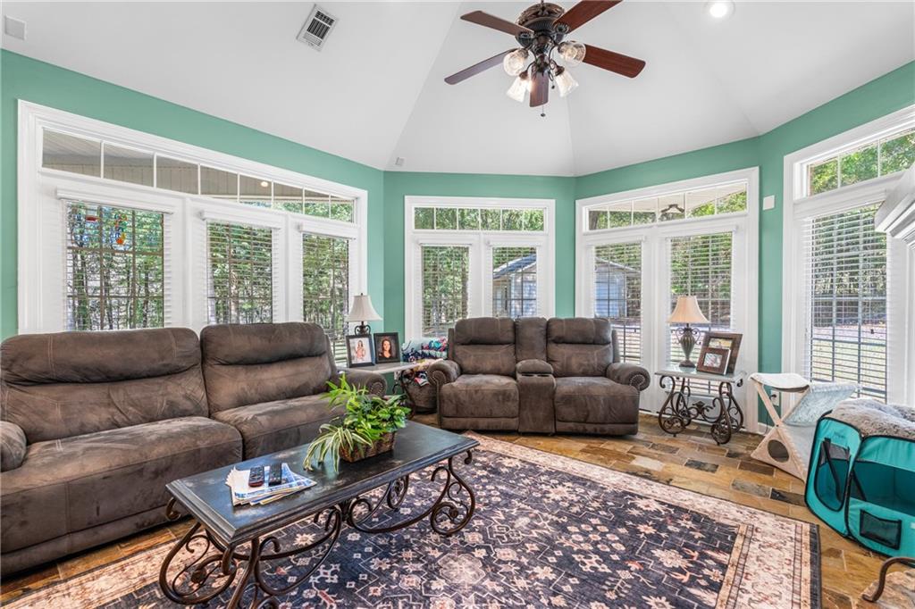 642 Nuckols Road Seale, AL 36875 - Photo 26 of 48 Vaulted ceiling with a ceiling fan, abundant natural light, transom windows, and tile flooring