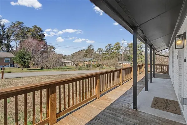 a view of a balcony with wooden floor