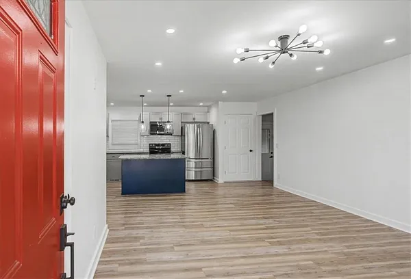 a view of a kitchen with a sink and refrigerator