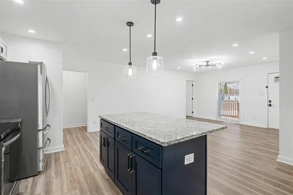 a kitchen with a sink refrigerator and microwave