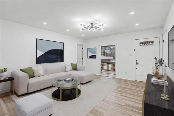 a living room with furniture and wooden floor