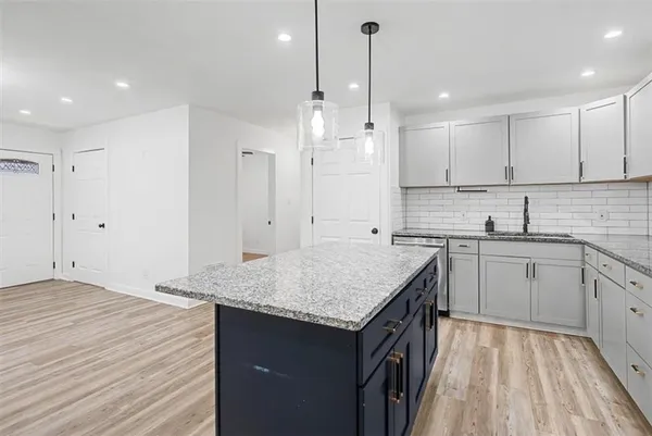 a kitchen with a sink window and cabinets