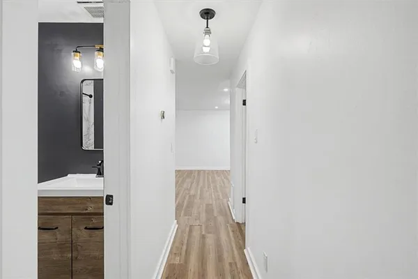 a view of a bathroom from a hallway