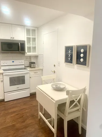 a kitchen with a sink a stove a microwave and cabinets