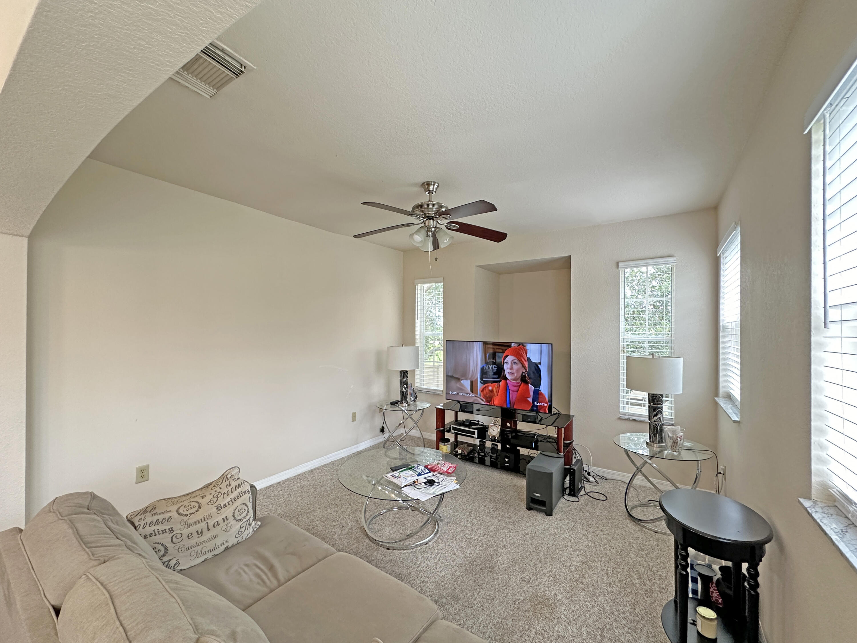 166 Southwest Peacock Boulevard, Unit 34202 Port St. Lucie, FL 34986 - Photo 14 of 56 a living room with furniture and a flat screen tv