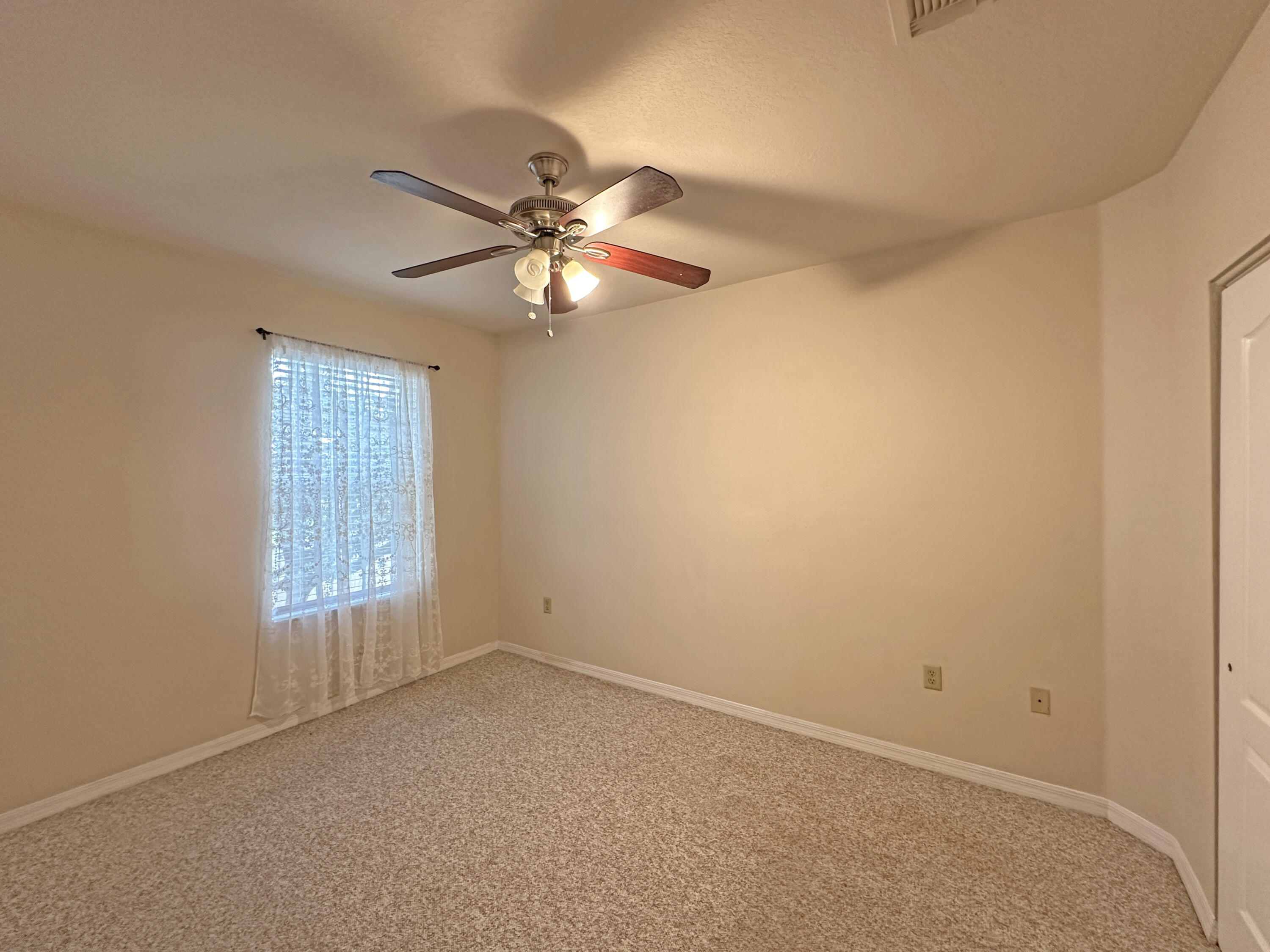 166 Southwest Peacock Boulevard, Unit 34202 Port St. Lucie, FL 34986 - Photo 27 of 56 an empty room with windows and fan