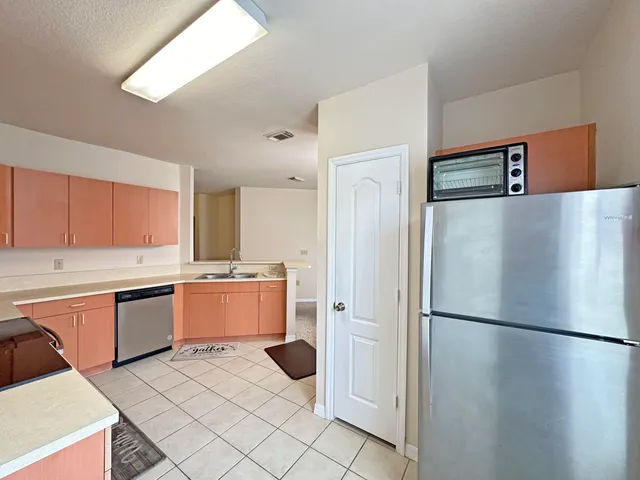 a kitchen with a refrigerator and a sink