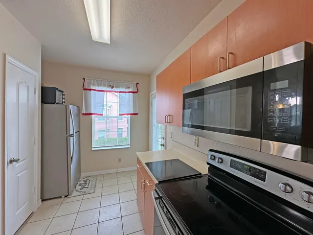 a kitchen with stainless steel appliances and cabinets