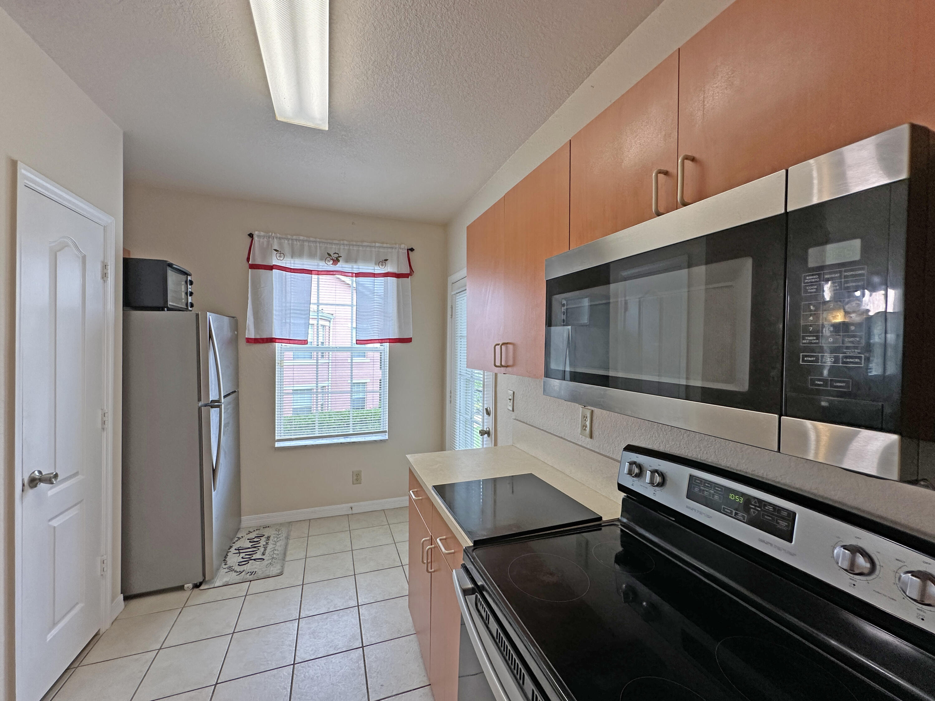 166 Southwest Peacock Boulevard, Unit 34202 Port St. Lucie, FL 34986 - Photo 7 of 56 a kitchen with stainless steel appliances and cabinets