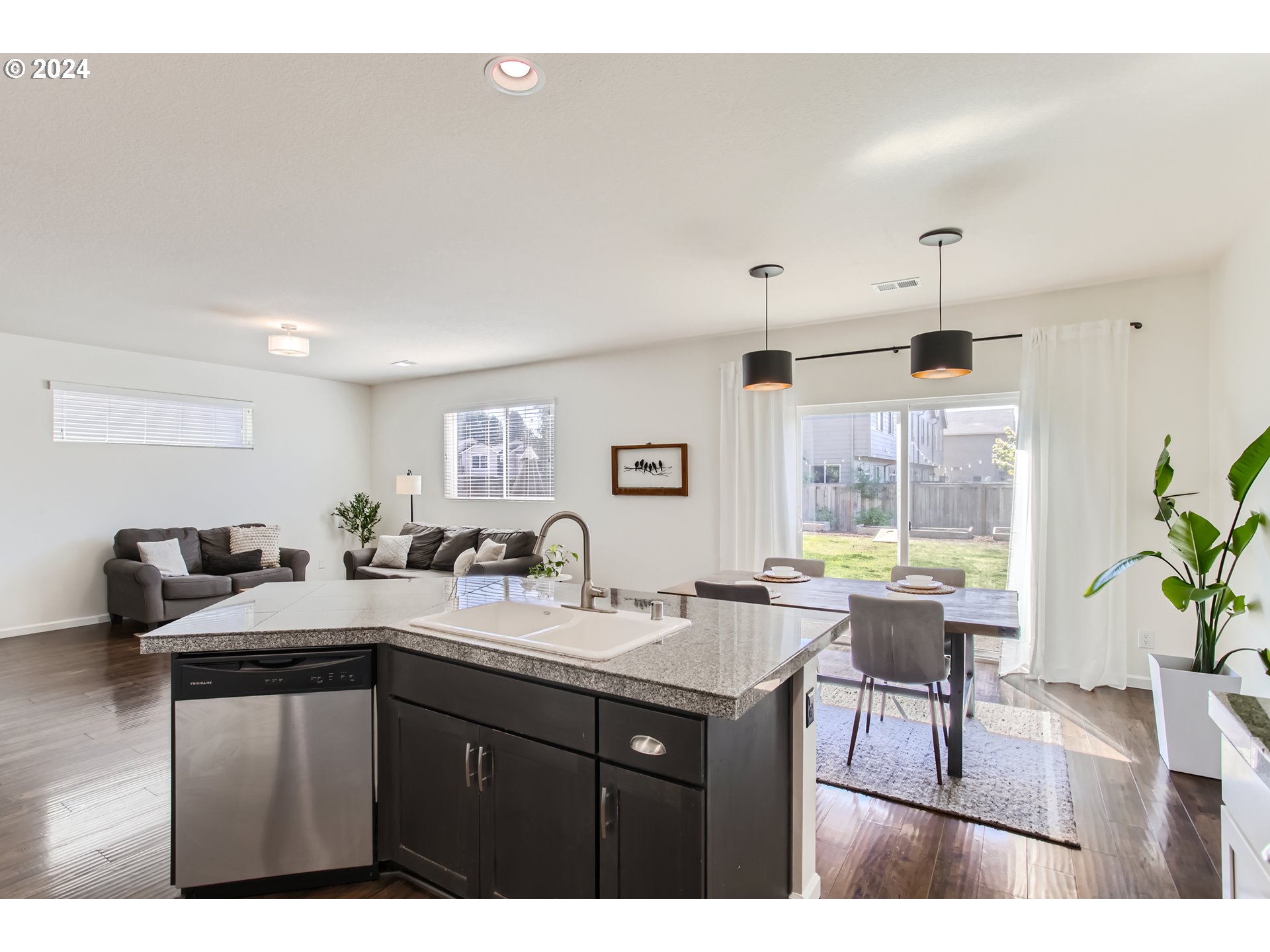 263 North 34th Court Ridgefield, WA 98642 - Photo 11 of 40 a kitchen with a sink a counter space and a dining table
