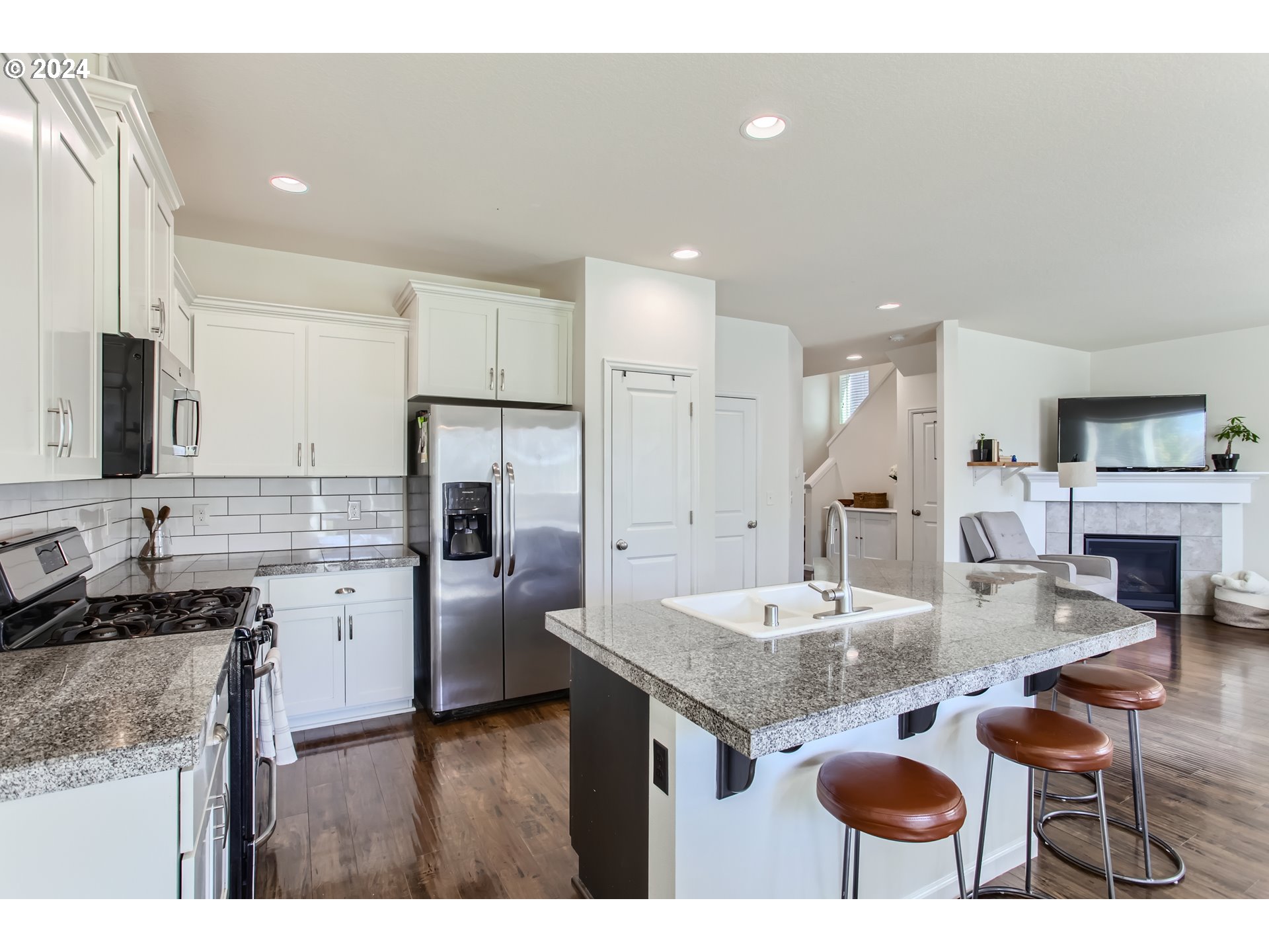 263 North 34th Court Ridgefield, WA 98642 - Photo 12 of 40 a kitchen with stainless steel appliances granite countertop a sink stove and refrigerator
