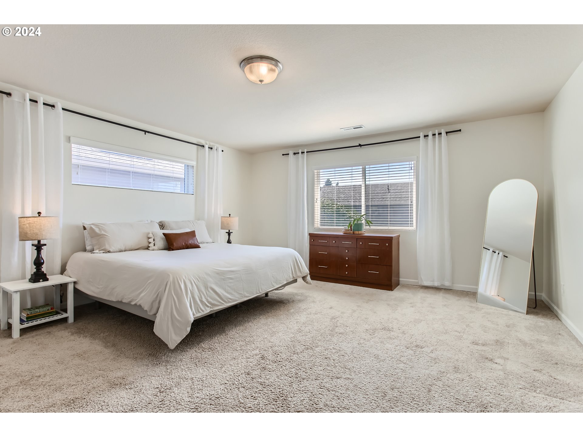 263 North 34th Court Ridgefield, WA 98642 - Photo 14 of 40 a spacious bedroom with a bed and a large window