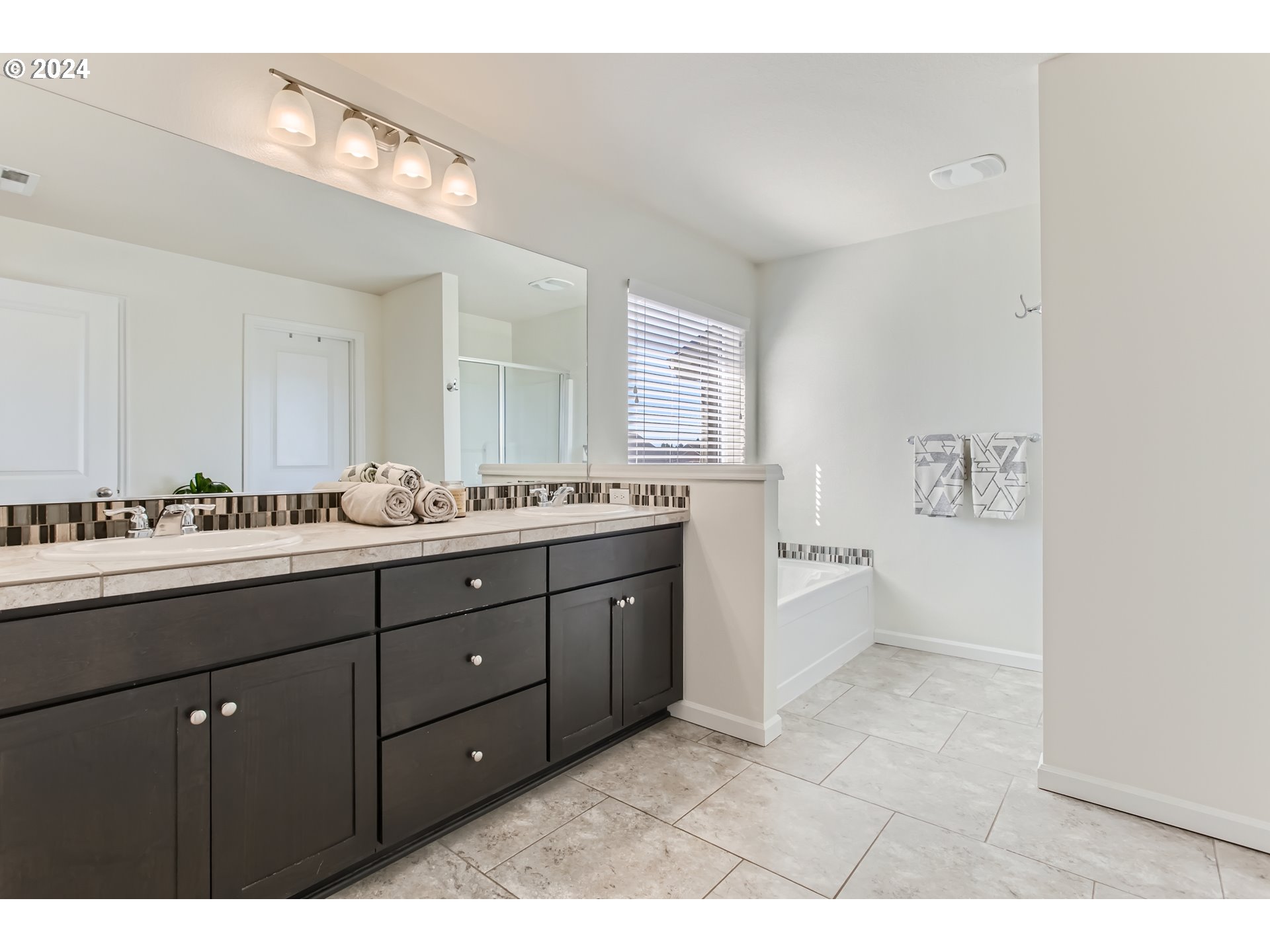 263 North 34th Court Ridgefield, WA 98642 - Photo 19 of 40 a spacious bathroom with a granite countertop double vanity sink mirror and bathtub
