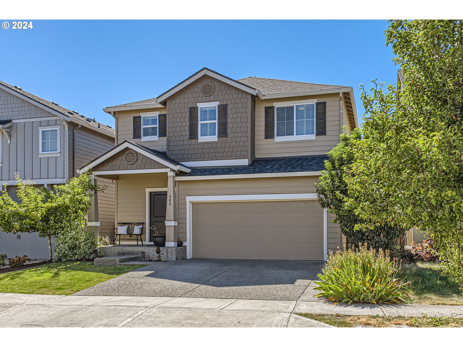 263 North 34th Court Ridgefield, WA 98642 - Photo 2 of 40 a front view of a house with a yard and garage
