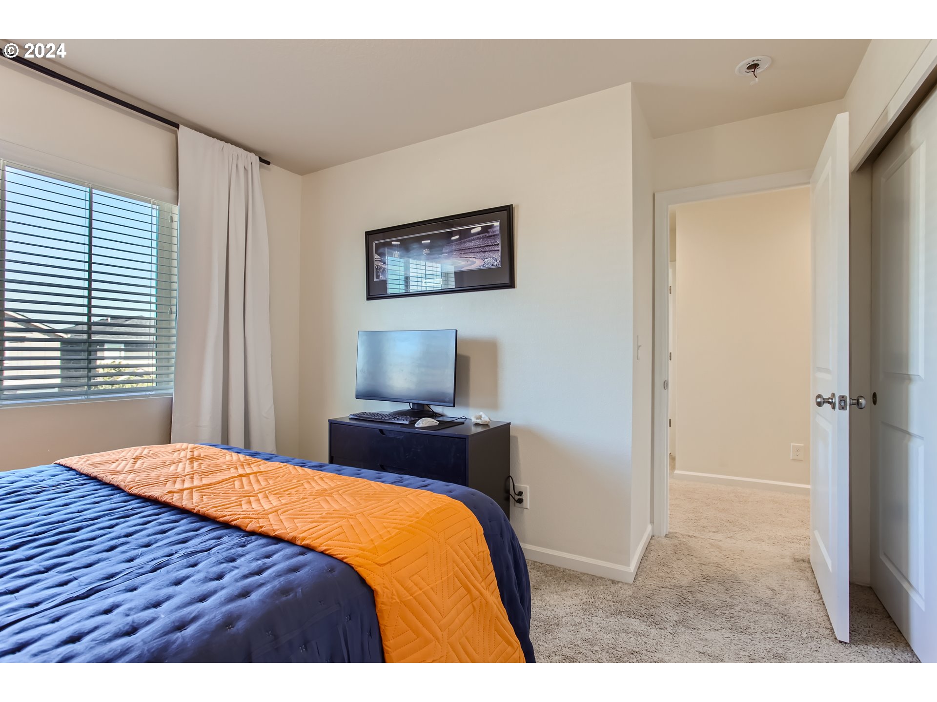 263 North 34th Court Ridgefield, WA 98642 - Photo 25 of 40 a bedroom with a bed and a flat screen tv