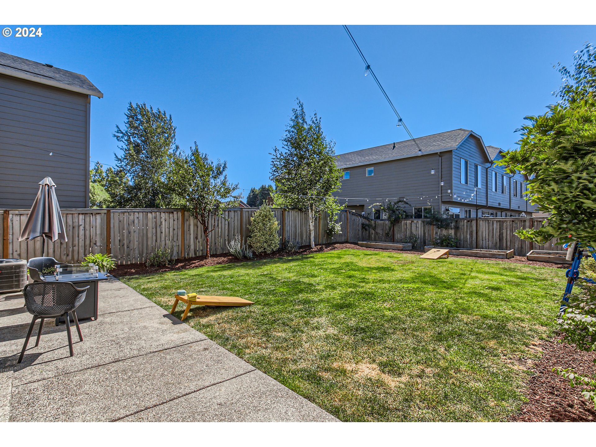 263 North 34th Court Ridgefield, WA 98642 - Photo 32 of 40 a backyard of a house with table and chairs