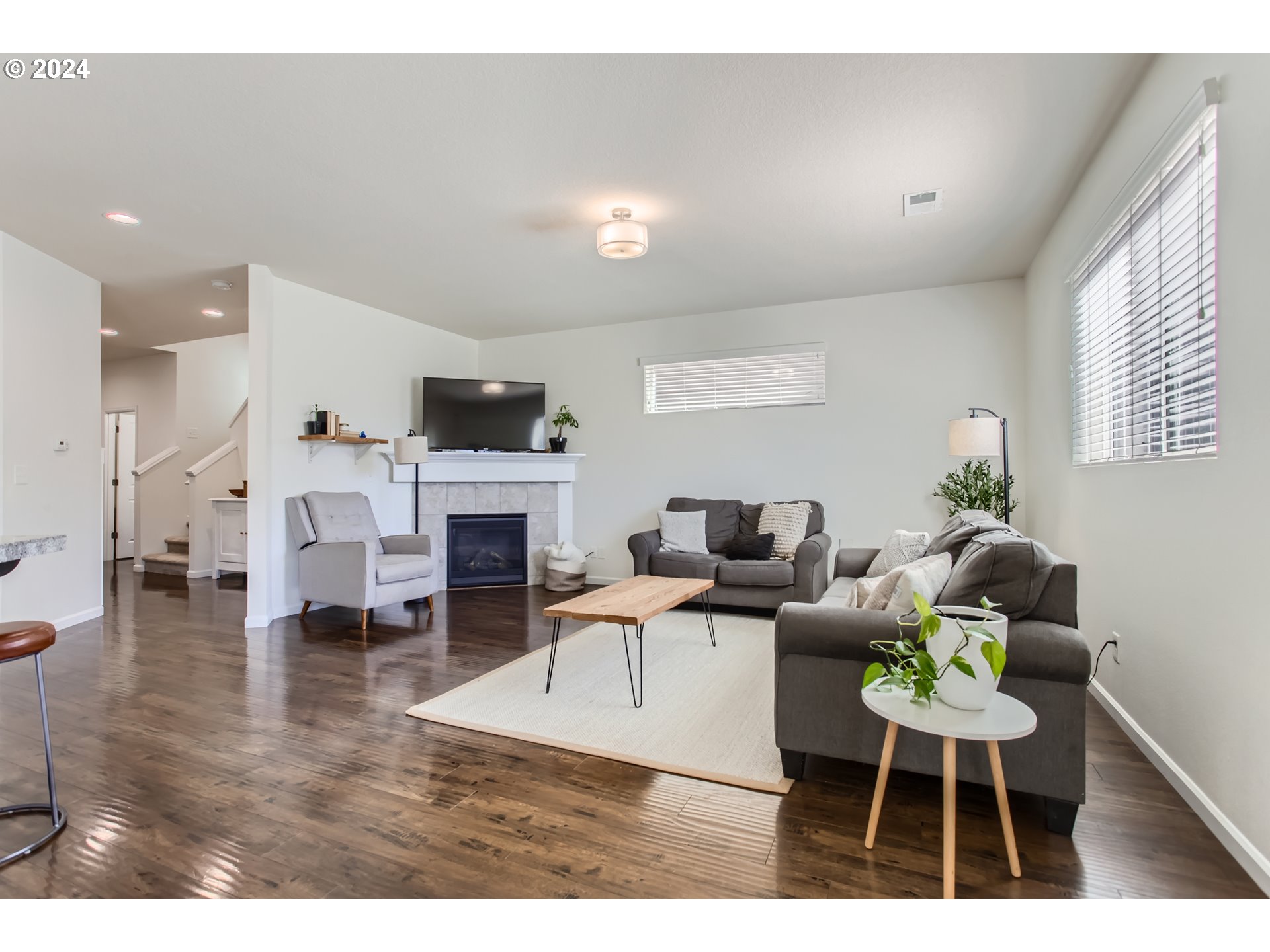 263 North 34th Court Ridgefield, WA 98642 - Photo 6 of 40 a living room with furniture a fireplace and a flat screen tv