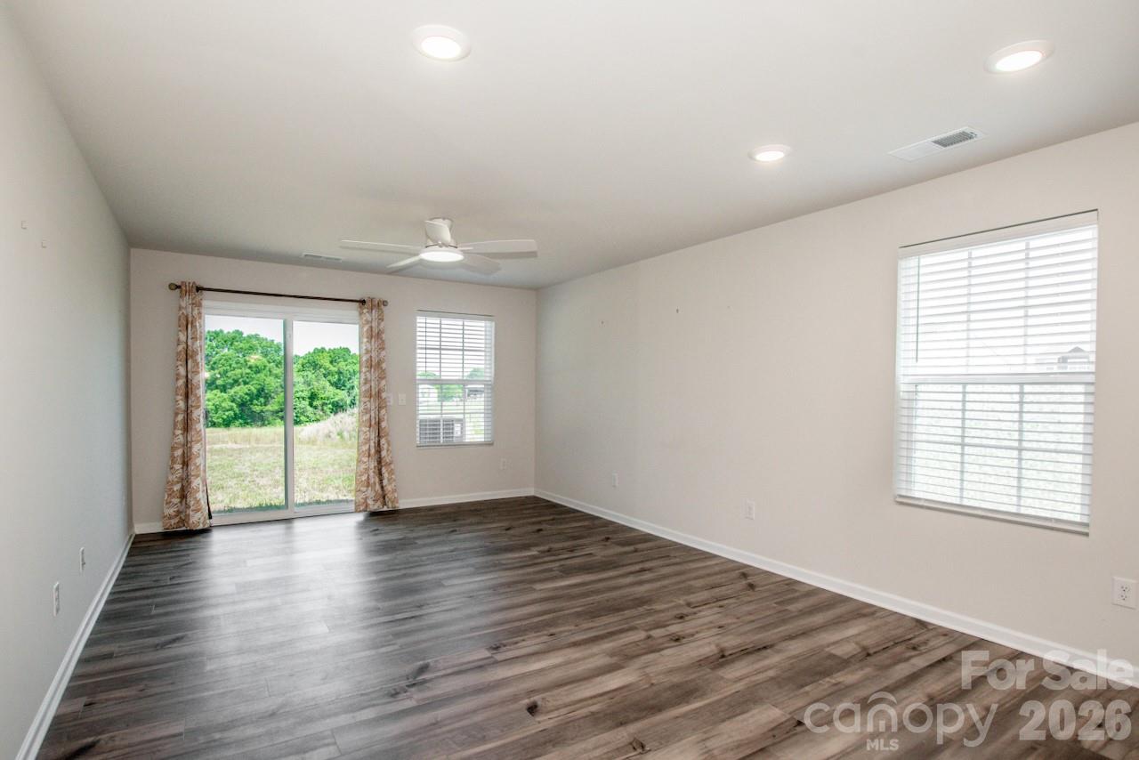 2742 Legacy Ridge Lane Catawba, NC 28609 - Photo 21 of 36 an empty room with wooden floor and windows