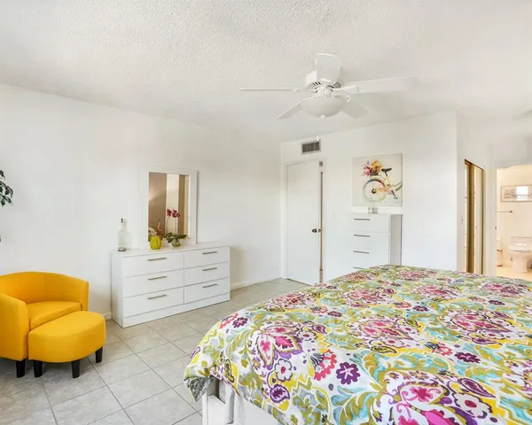 a bedroom with a bed and a chair