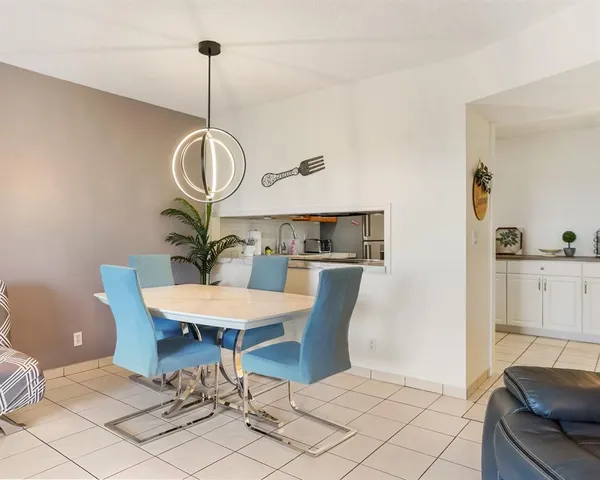 a view of a dining room with furniture and chandelier
