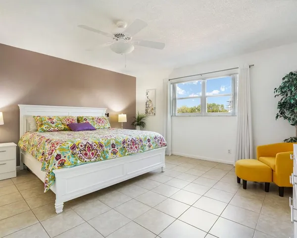 a bedroom with a bed and window