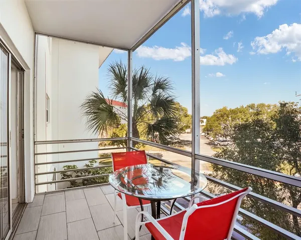 a balcony with furniture and a potted plant