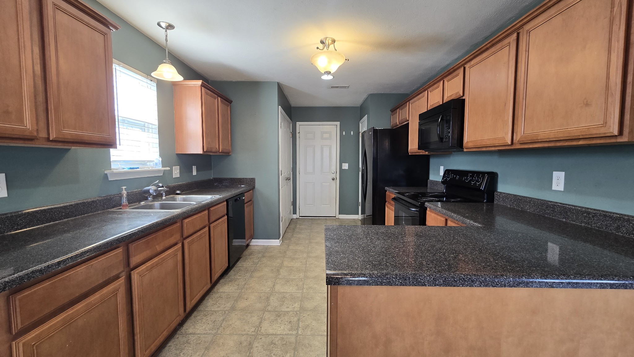 287 Davids Way La Vergne, TN 37086 - Photo 7 of 21 a kitchen with stainless steel appliances granite countertop a sink dishwasher stove and microwave with wooden cabinets