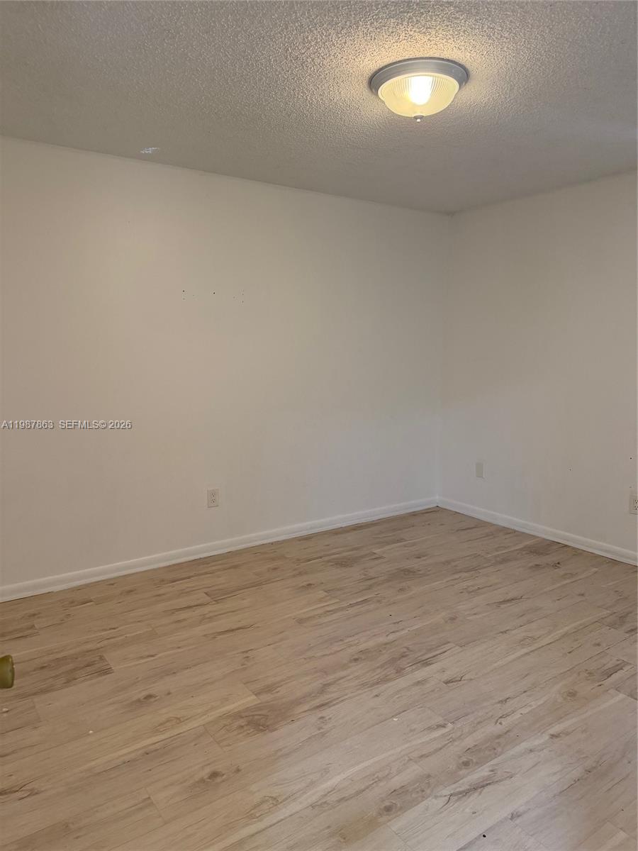 1419 Yellowthroat Street Homestead, FL 33035 - Photo 11 of 26 a view of an empty room and wooden floor