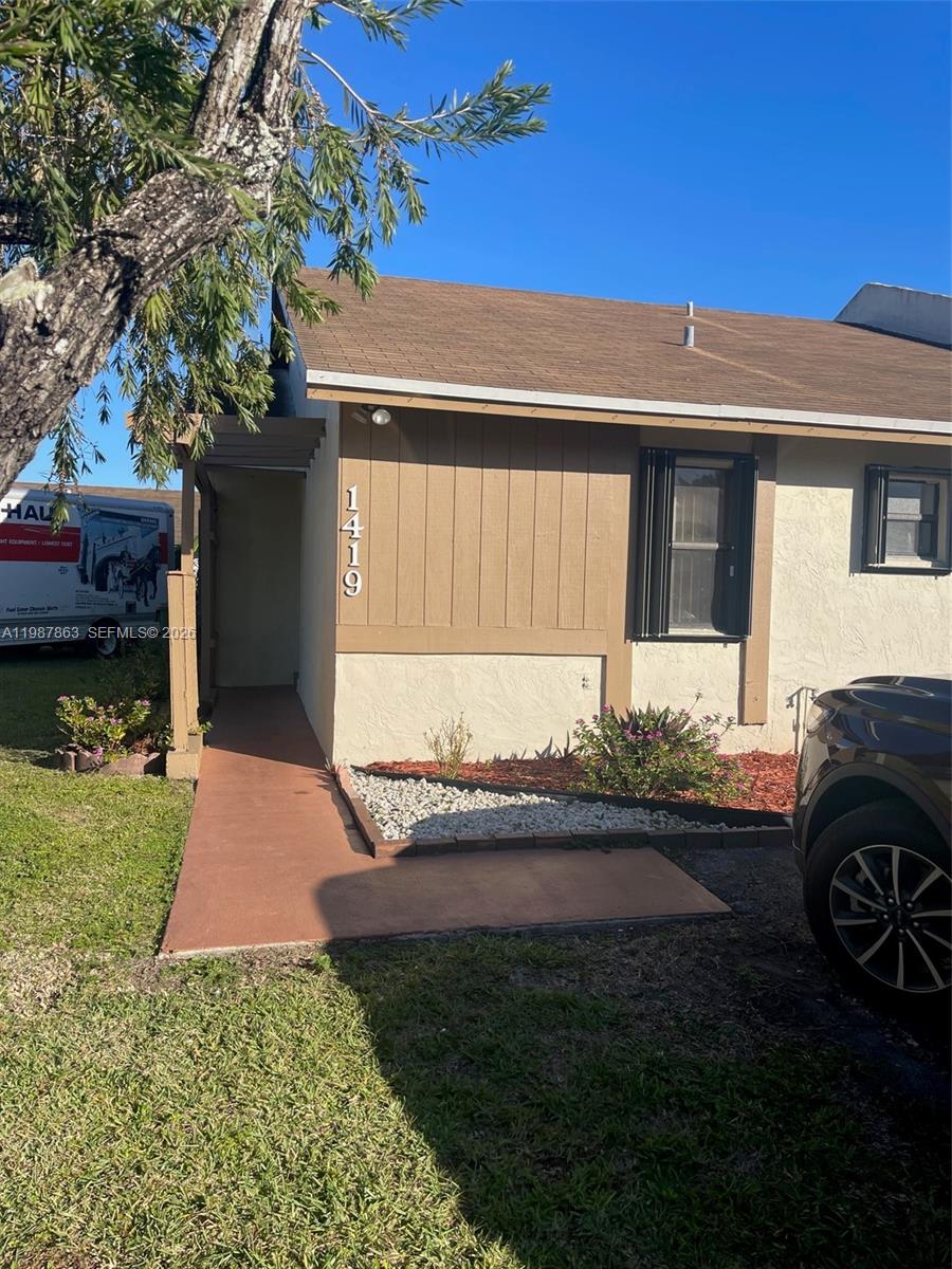 1419 Yellowthroat Street Homestead, FL 33035 - Photo 15 of 26 a front view of a house with a garden and yard