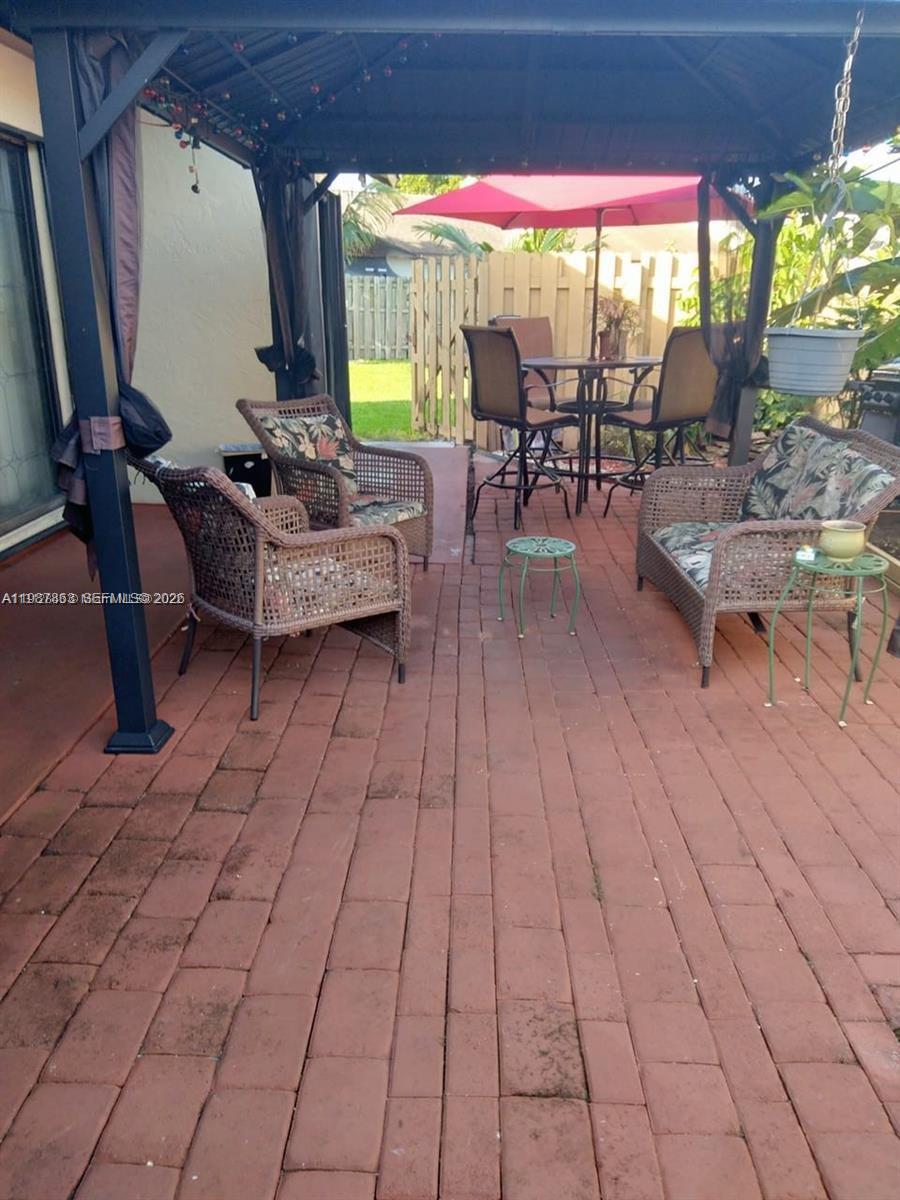 1419 Yellowthroat Street Homestead, FL 33035 - Photo 25 of 26 a outdoor space with lots of tables a garden and chairs
