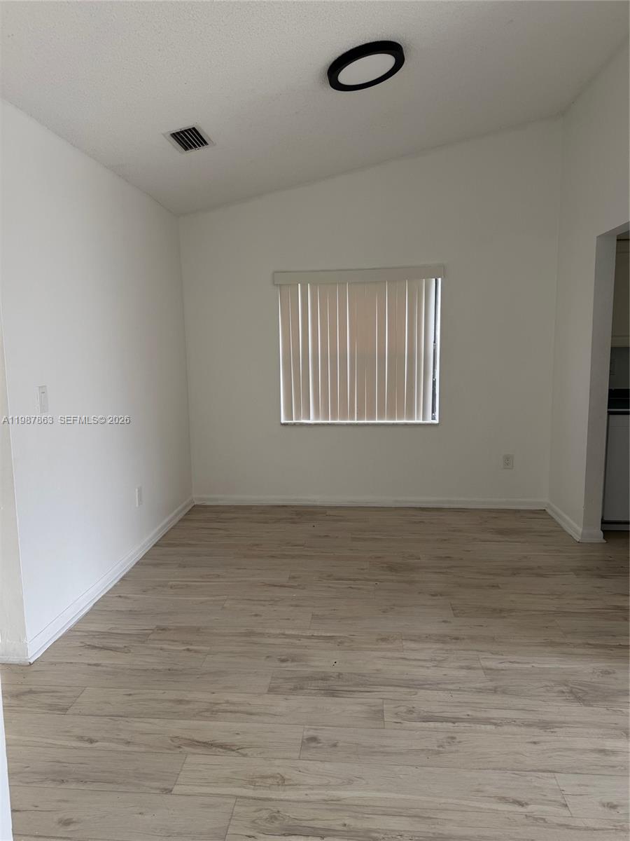 1419 Yellowthroat Street Homestead, FL 33035 - Photo 4 of 26 wooden floor in an empty room with a window