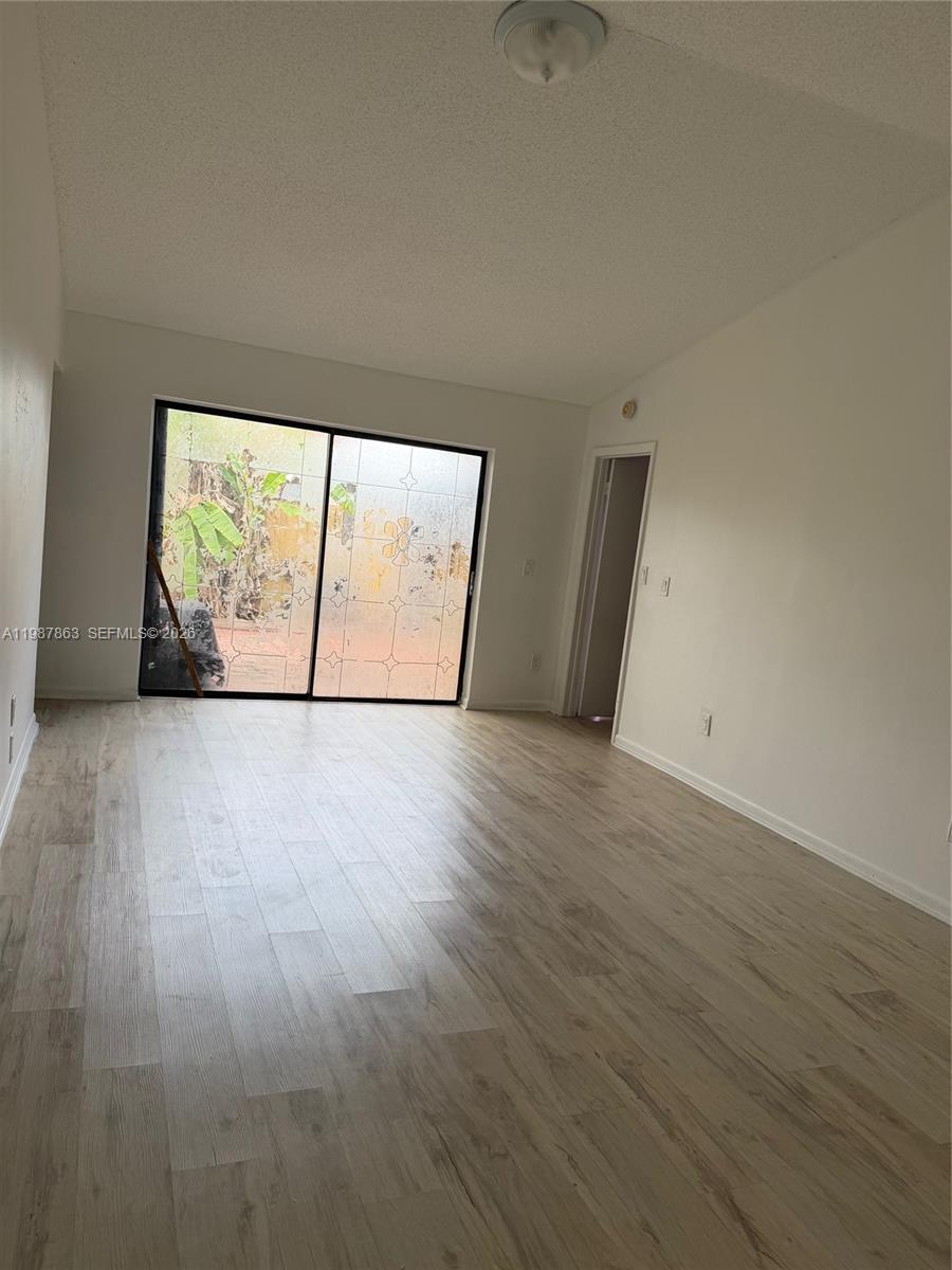 1419 Yellowthroat Street Homestead, FL 33035 - Photo 5 of 26 a view of empty room with wooden floor and fan