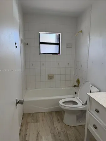 a bathroom with a toilet a sink and bathtub