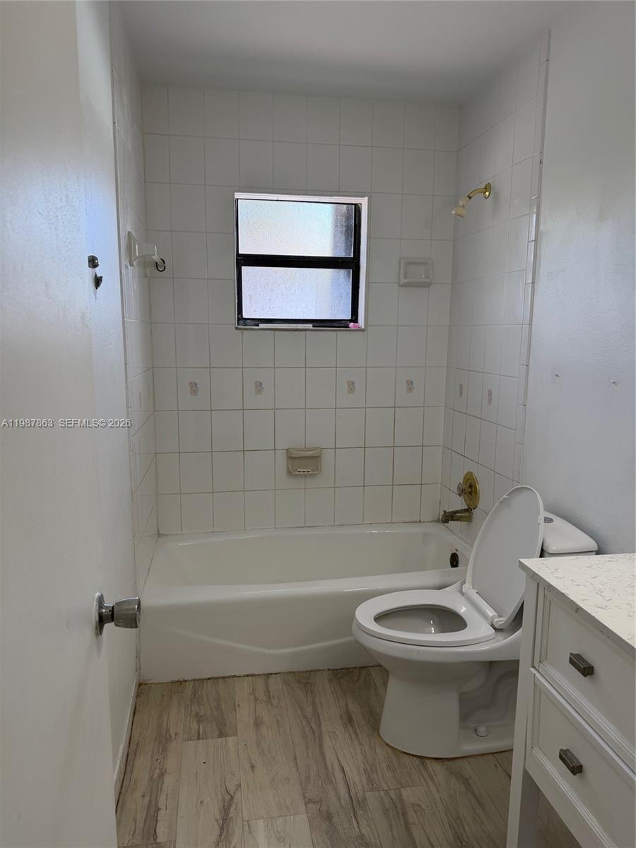 1419 Yellowthroat Street Homestead, FL 33035 - Photo 9 of 26 a bathroom with a toilet a sink and bathtub