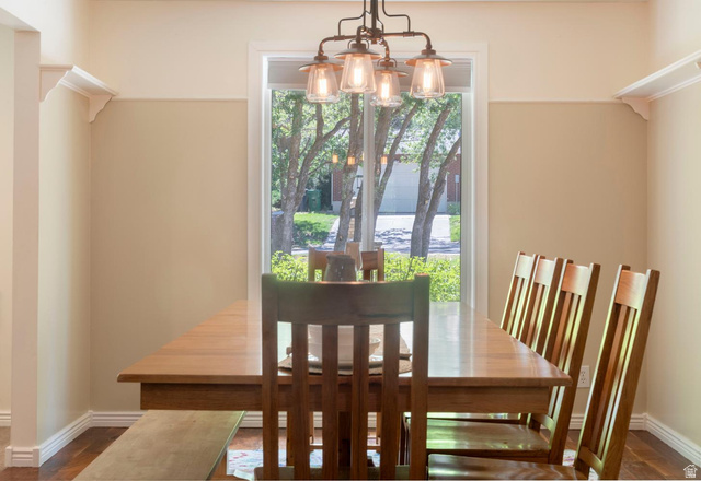 9676 Mt Jordan Road Sandy, UT 84092 - Photo 12 of 38 Window-framed dining area featuring a linear pendant light fixture with clear glass shades