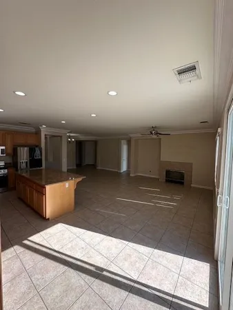 an empty room with windows and fireplace