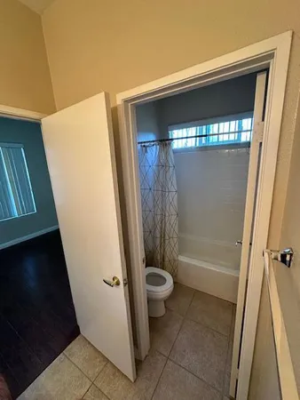 a bathroom with a bathtub sink and mirror