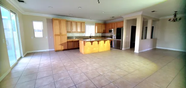 a kitchen with stainless steel appliances granite countertop a sink counter space and a view of living room