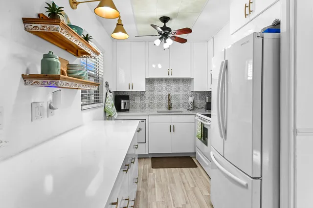 a kitchen with stainless steel appliances a refrigerator and a stove