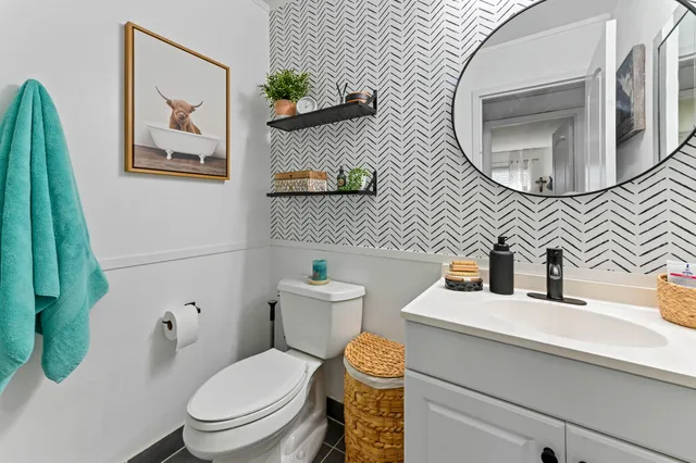 a bathroom with a toilet sink and mirror