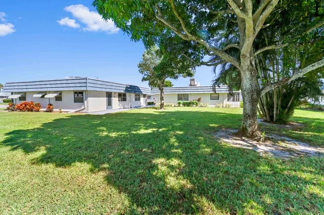 a house view with a sitting space and garden